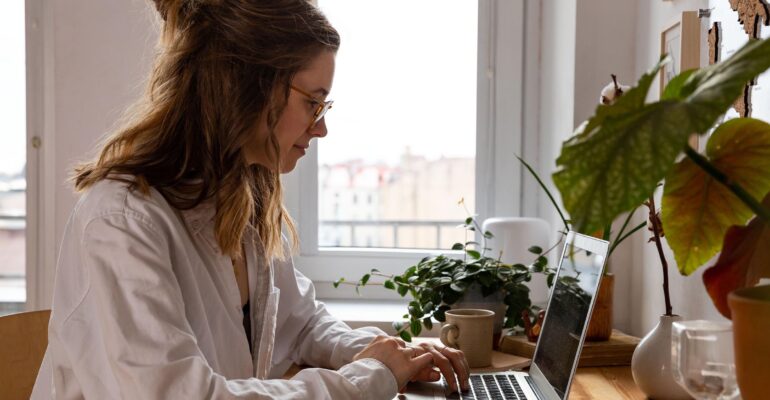 smiling-woman-freelancer-looking-webinar-working-o-AKDSYKN